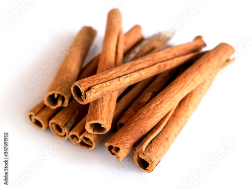 Herbs and spices with cinnamon roll sticks isolated on white backgeound.