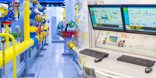 Complex gas distribution station equipment. Yellow pipes and control panel at the enterprise. Remote monitoring of machines. Workplace of the engineer on duty.