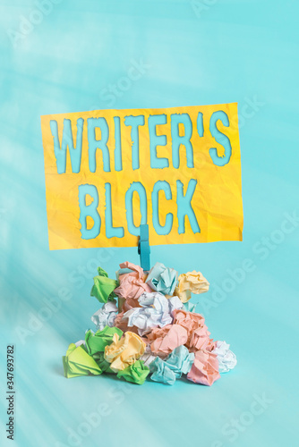 Handwriting text Writer S Block. Conceptual photo Condition of being unable to think of what to write Reminder pile colored crumpled paper clothespin reminder blue background photo