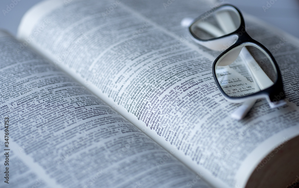Fototapeta premium Dictionary and glasses