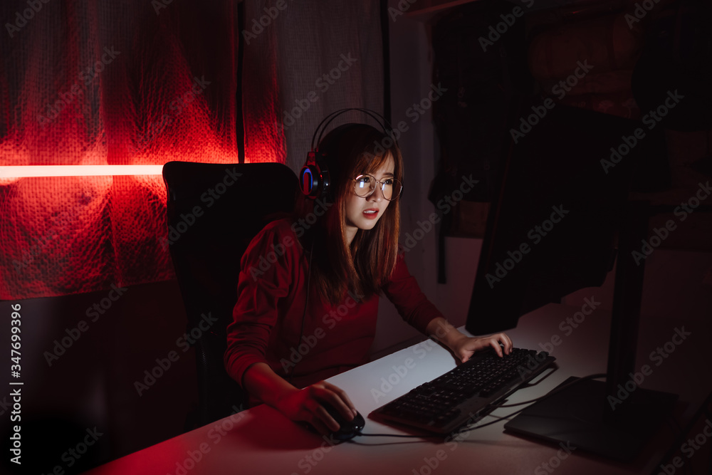 Pro Player Gamer Young Asian Woman Playing Online Video Game Shooting Fps  Tournament Ranking Cyber Internet At Night Red Neon Light Room With Gaming  Headset And Keyboard On Championship Event Stock Photo 