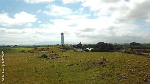 Aerial drone shot, rising, wide angle of the Cape Egmont Lighthouse in New Plymouth, Taranaki, New Zealand photo