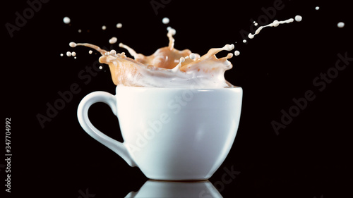 A cup with a large splash of coffee.
