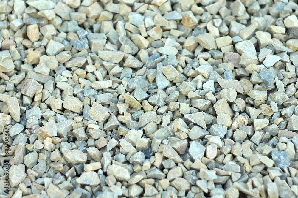 Background of blue and gray gravel. Small stones lie on the ground at a construction site. Pebble pattern on the beach. Background of blue and gray gravel. Small stones lie on the ground at a construction site. Pebble pattern on the beach.