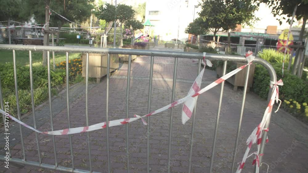 Barrier tape - quarantine, isolation, entry ban. Do not cross on the park Barrier tape - quarantine, isolation, entry ban. Do not cross on the park