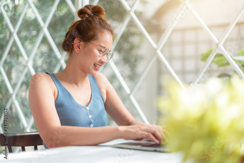 Beautiful girls use laptops to work at home in Home office. A happy girls uses his laptop to check email and check work online. Work at home concept. Free Download Beautiful girls use laptops to work at home in Home office. A happy girls uses his laptop to check email and check work online. Work at home concept. - GFXLoad