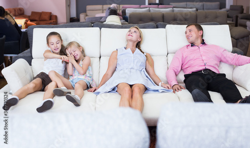 Family which is choosing new sofa-transforme