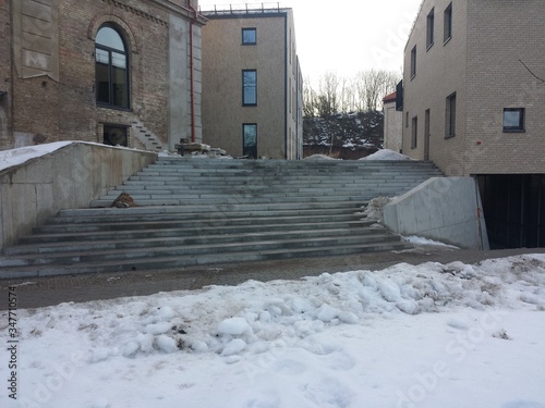 Pedestrian path and street in the city covered with cnow photo