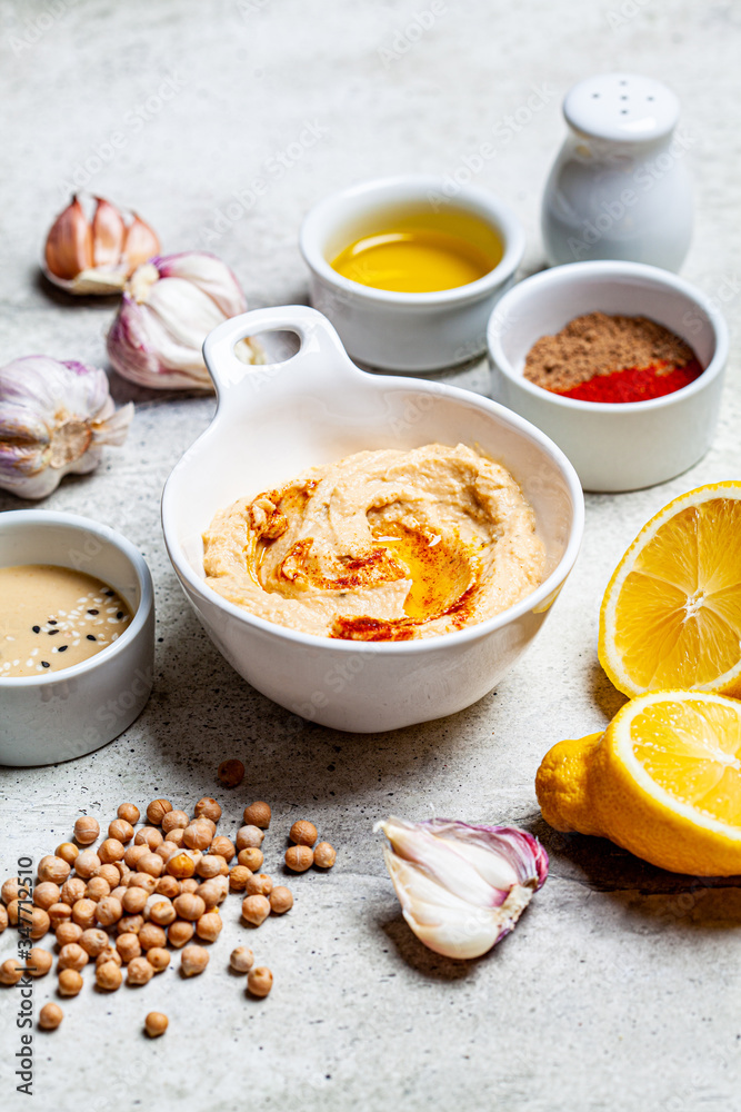 Hummus bowl and ingredients for making hummus. Vegan food concept. Hummus bowl and ingredients for making hummus. Vegan food concept.