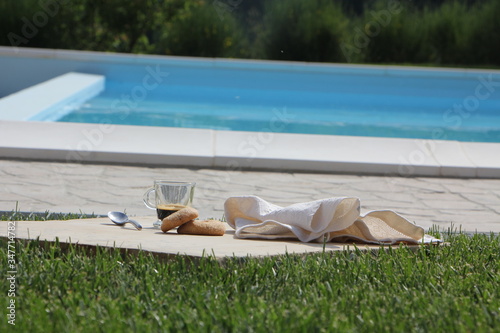 Breakfast by the pool with coffee and donuts. Relaxation and luxury for rest photo