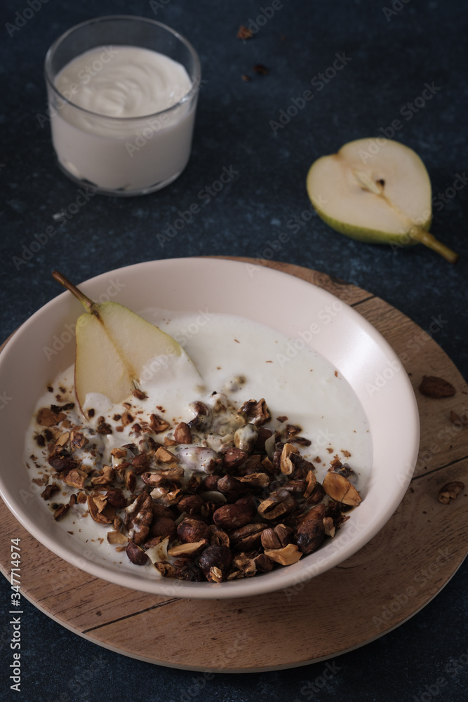 Granola with pear and greek yogurt. Vegetarian breakfast. Healthy eating. Granola with pear and greek yogurt. Vegetarian breakfast. Healthy eating.