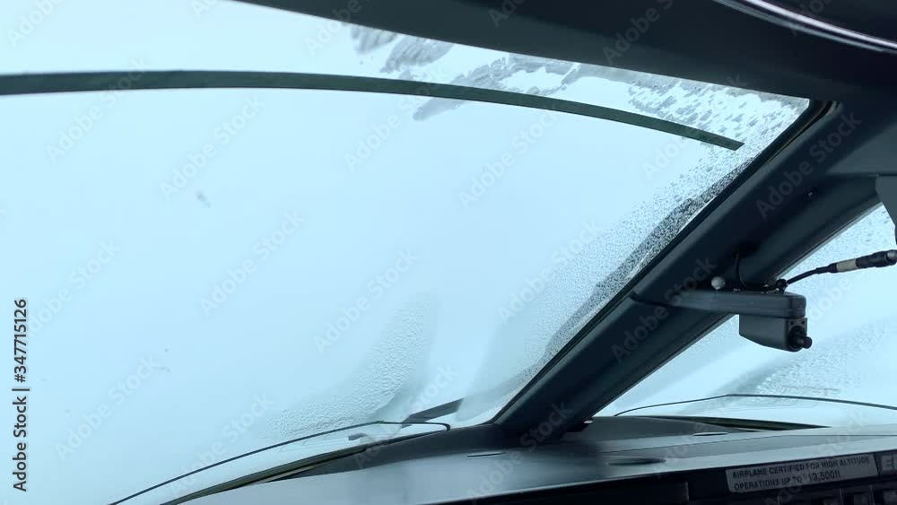 Ice on Aircraft Windshield Flying through Clouds. Pilot Point of View. Ice on Aircraft Windshield Flying through Clouds. Pilot Point of View.