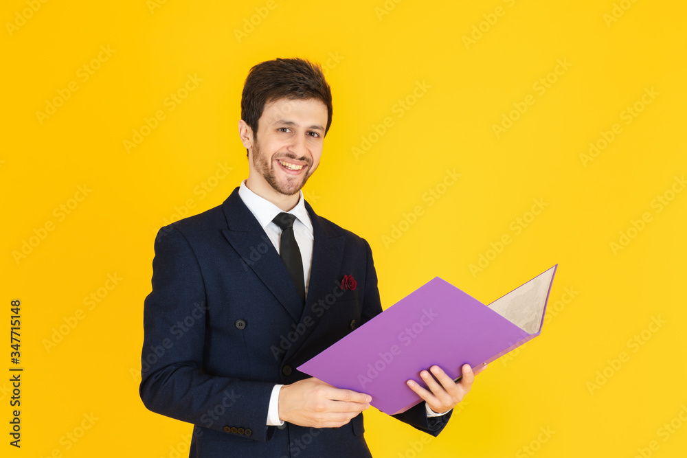 A businessman with the yellow isolated background. A businessman with the yellow isolated background.