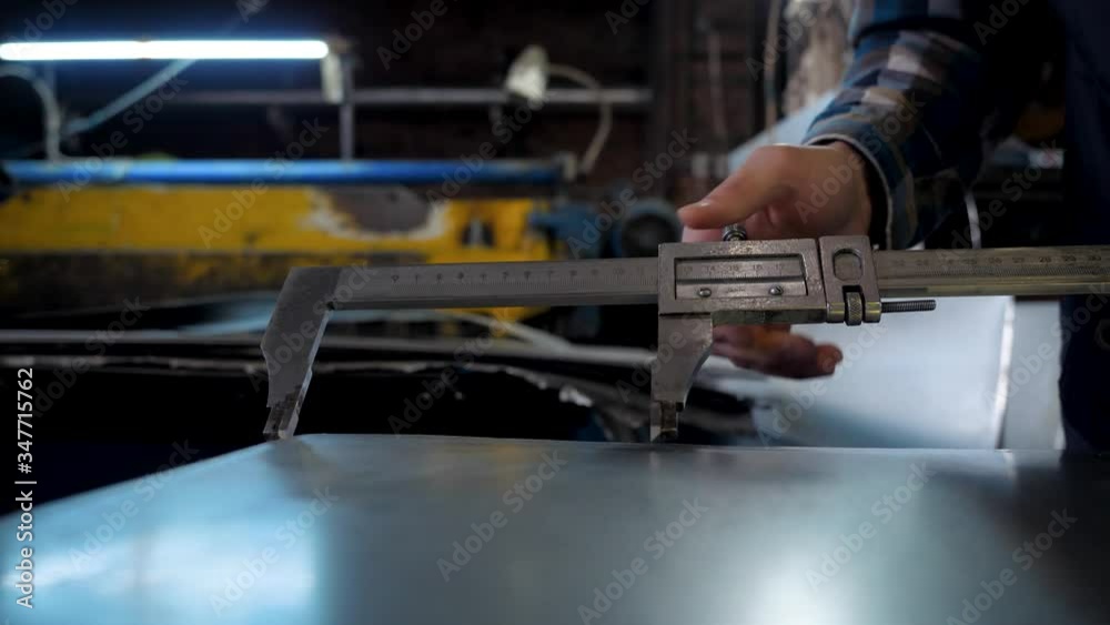 Work with caliper in hands at the factory Work with caliper in hands at the factory