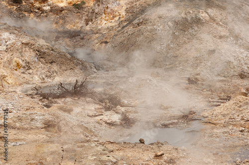 Close up view of steam rising from the ground on volcano land