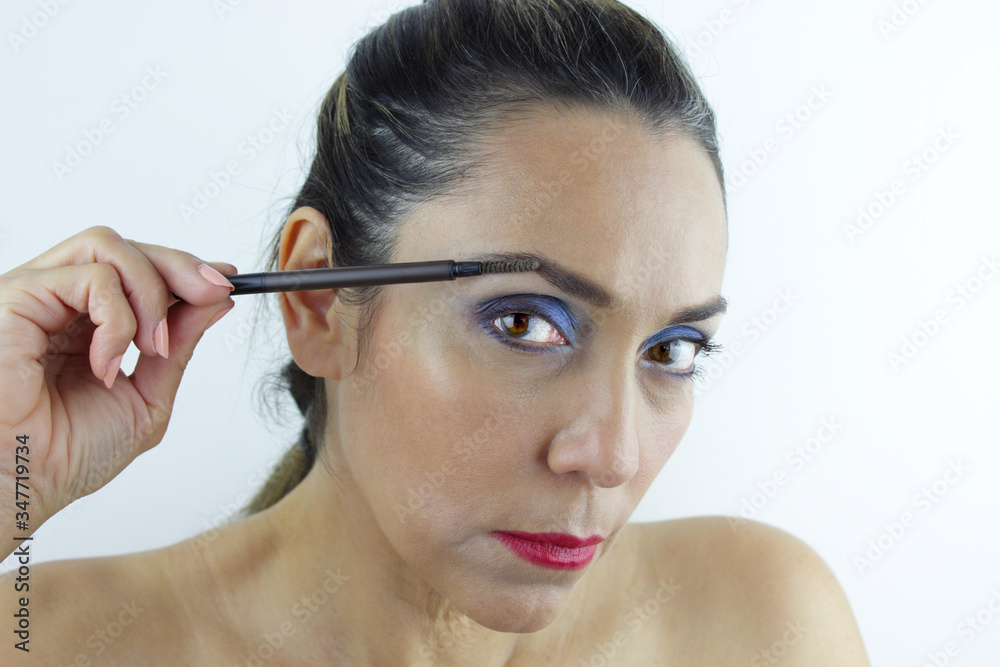 Fototapeta premium Beautiful Colombian woman fixing her eye brows