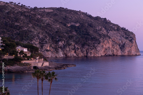 aerial view over Rocks, cliffs, island and sea water during sunset from the view point cap andritxol in Camp de Mar, Majorca island, Spain photo