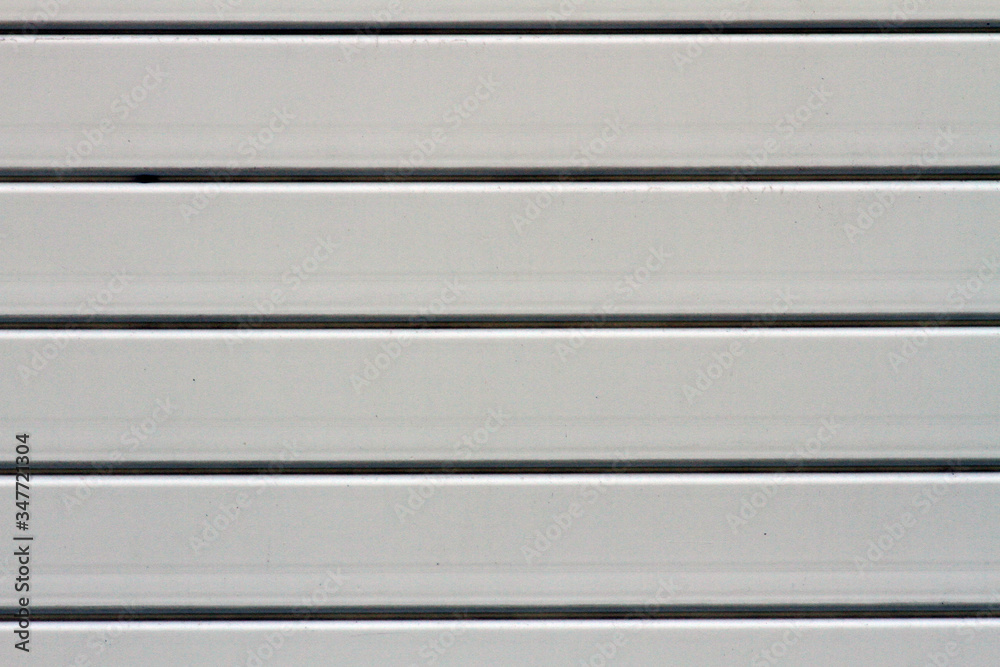 Light white curtain backdrop close-up modern plastic shutter blinds in office room home plastic panels texture background. Light white curtain backdrop close-up modern plastic shutter blinds in office room home plastic panels texture background.