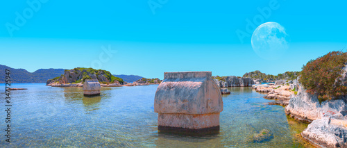 The ancient Lycian sarcophagus in water with full moon - Simena village, Kekova, Turkey.