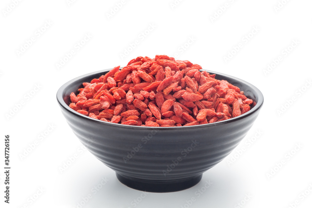 Dried goji berries (Chinese wolfberry) in a black bowl, Isolated on white background. Dried goji berries (Chinese wolfberry) in a black bowl, Isolated on white background.