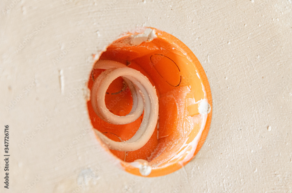 Naklejka premium Repair in the apartment. Socket. Putty knife. Wallpaper.