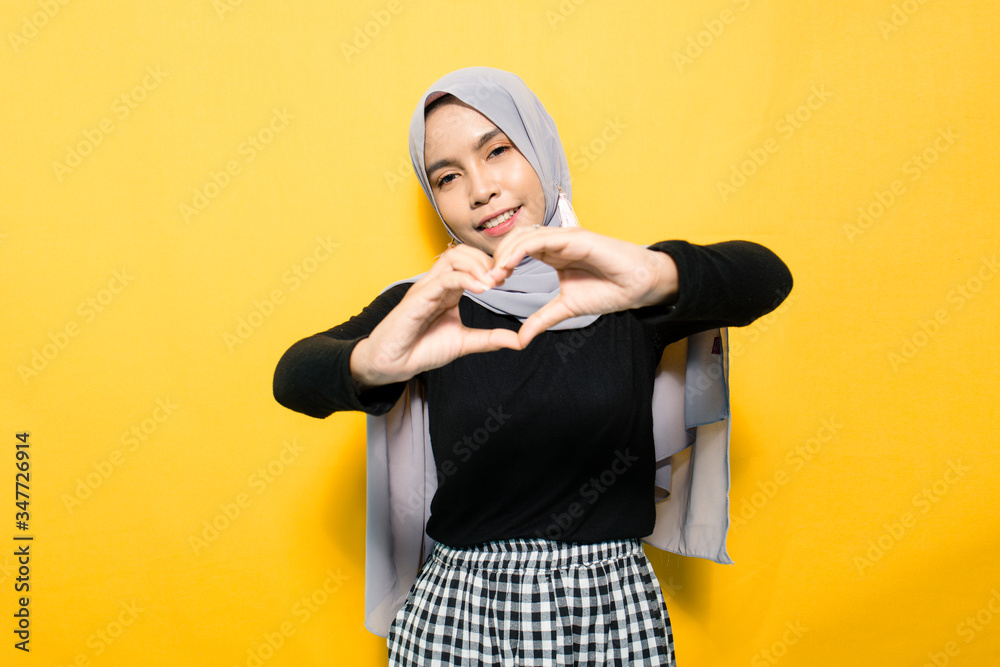 Asian women wearing hijab with sign love Asian women wearing hijab with sign love