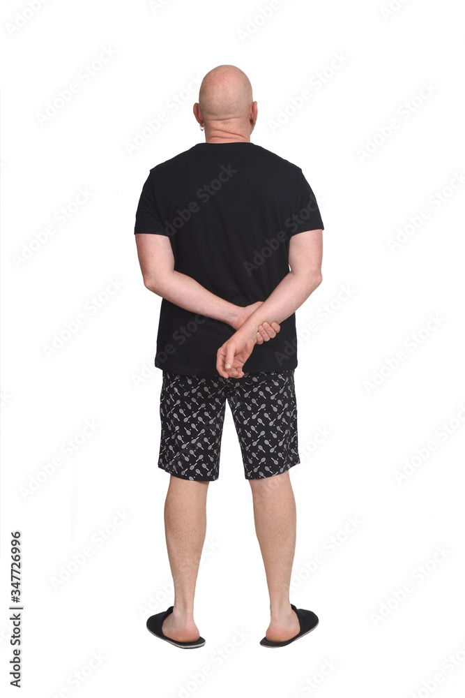 Fototapeta premium rear view of bald man in short pajamas on white background,hand crossed