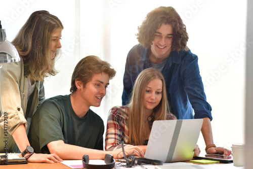 Group of students using laptop computer