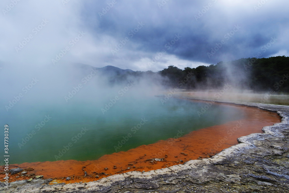 Geothermal lake with an orange shoreline