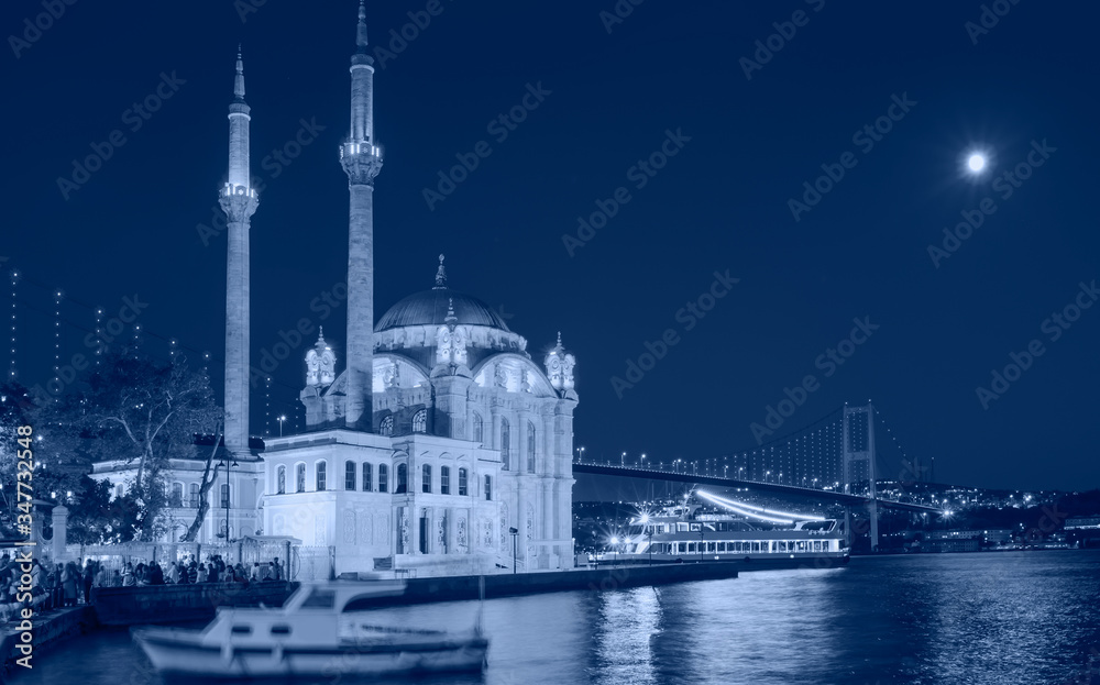 Naklejka premium Ortakoy mosque and Bosphorus bridge with moon - Istanbul, Turkey.