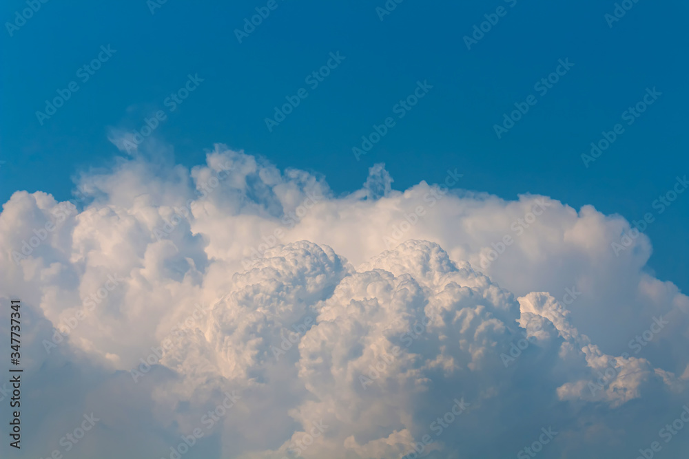 Dim blue sky with fluffy clouds Dim blue sky with fluffy clouds