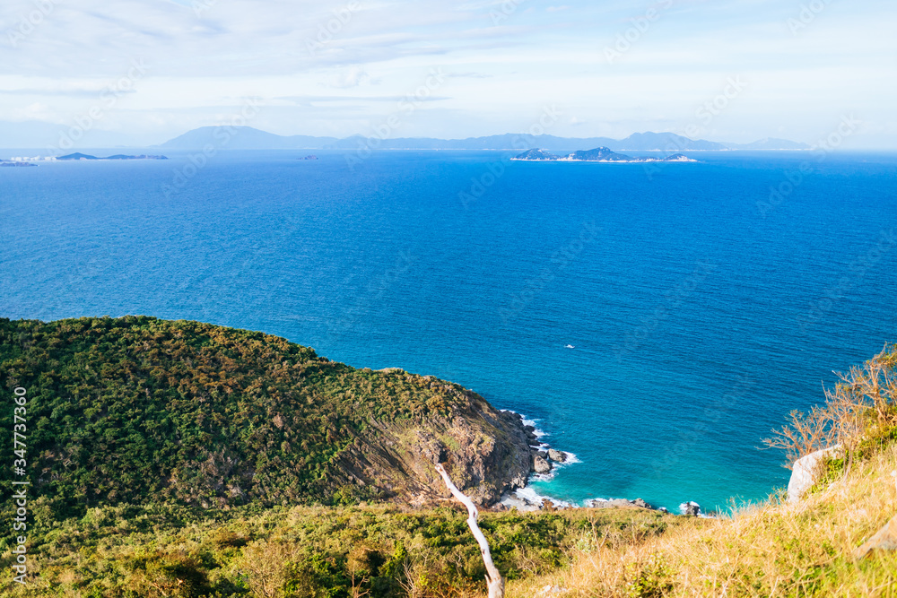 The blue sea, the hills covered with greenery in the background. Panoramic view of the sea landscape