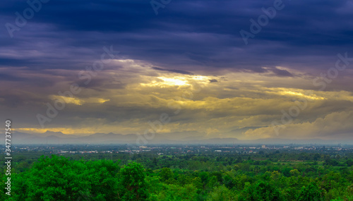 landsacpe view,green forest and city view with dim blue sky with yellow light