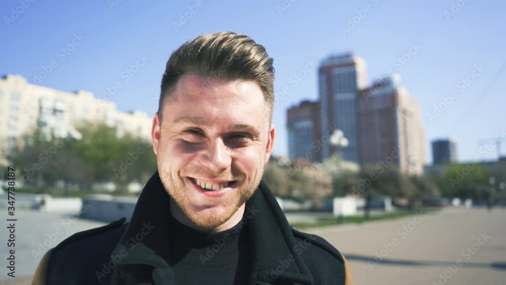Attractive stylish caucasian man stand on street and smile. Portrait