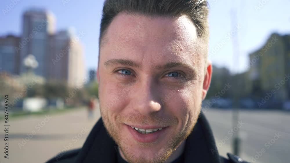 Young stylish caucasian man stand on street, looking at camera. Portrait close up Young stylish caucasian man stand on street, looking at camera. Portrait close up