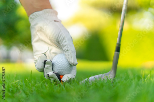 Golf ball on green grass field. sport golf club 