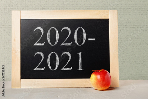 Fototapeta Naklejka Na Ścianę i Meble -  School board with numbers 2020 2021. Background School blackboard and apple. Beginning of the school year.