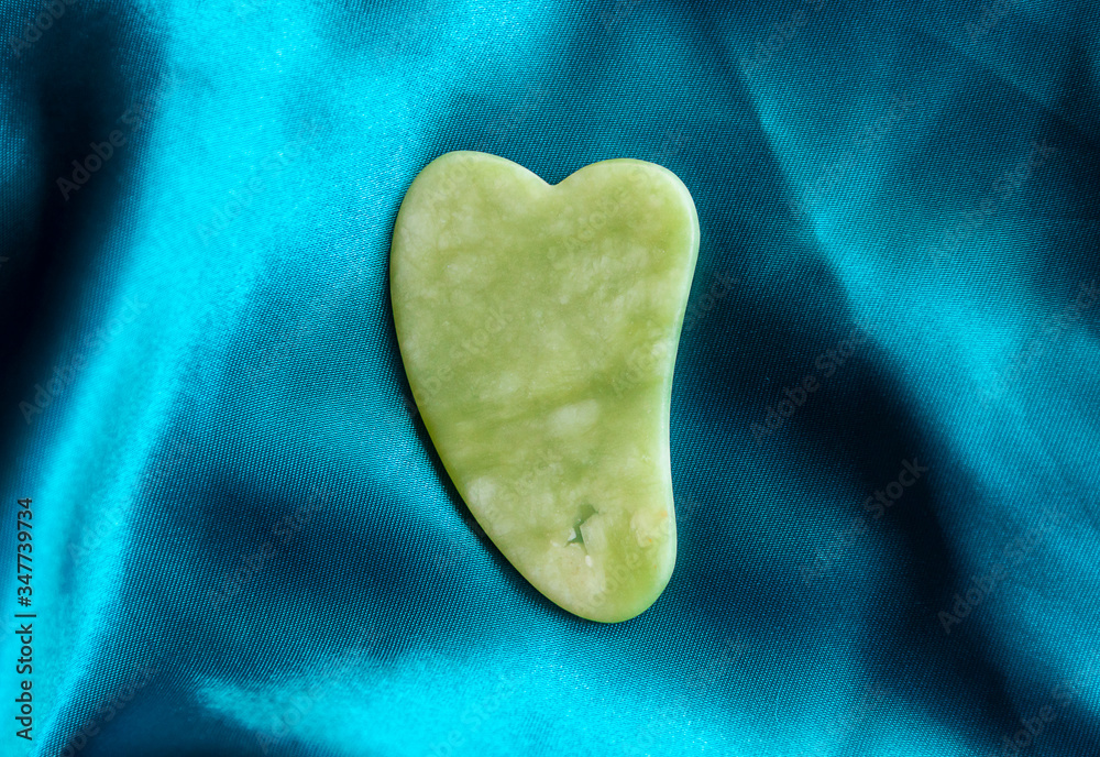 Fototapeta premium gua sha tool in natural gemstones of Green Jade