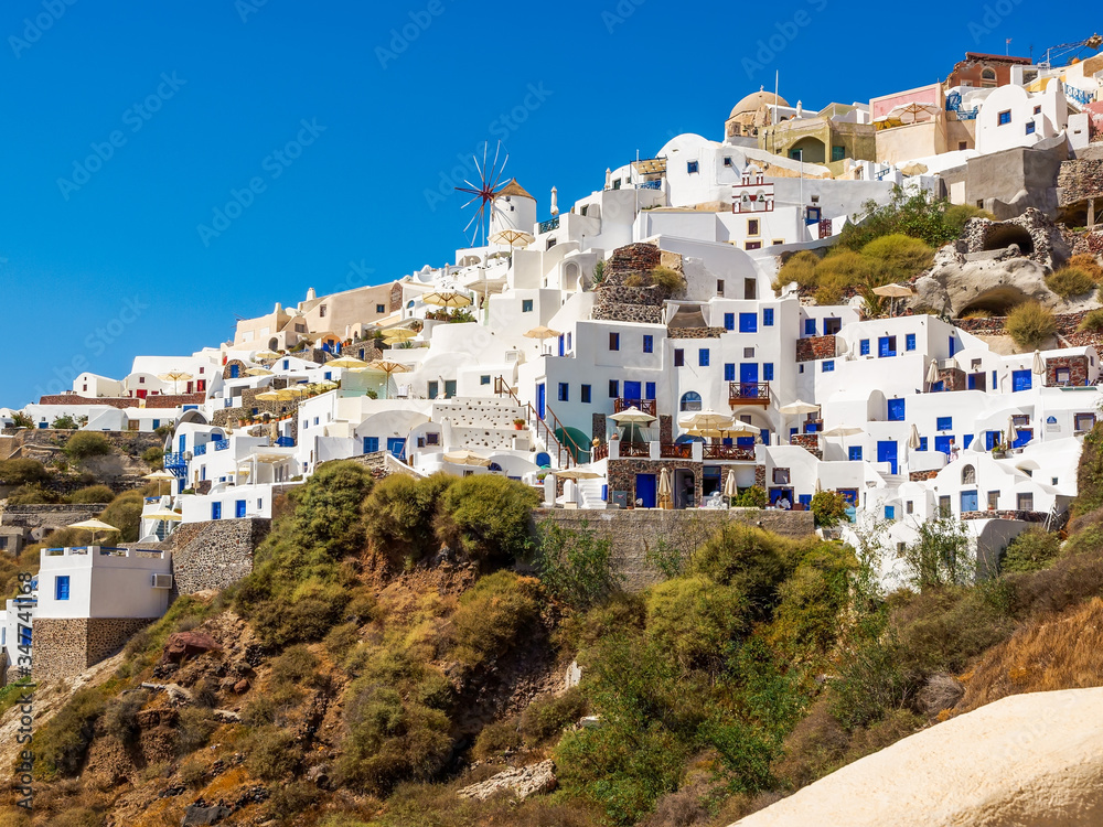 Amazing Santorini view on white cave houses from the Aegean sea. Cyclades, Greece