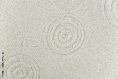 Abstract Zen drawing on white sand. Concept of harmony, balance and meditation, spa, massage, relax. Zen garden