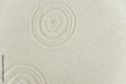Abstract Zen drawing on white sand. Concept of harmony, balance and meditation, spa, massage, relax. Zen garden