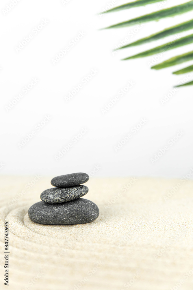 Zen garden. Pyramids of white and gray zen stones on the white sand with abstract wave drawings. Concept of harmony, balance and meditation, spa, massage, relax. Zen garden. Pyramids of white and gray zen stones on the white sand with abstract wave drawings. Concept of harmony, balance and meditation, spa, massage, relax.