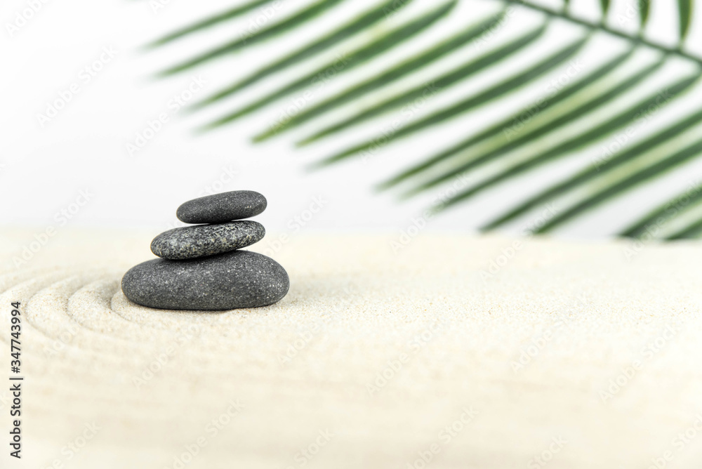 Zen garden. Pyramids of white and gray zen stones on the white sand with abstract wave drawings. Concept of harmony, balance and meditation, spa, massage, relax. Zen garden. Pyramids of white and gray zen stones on the white sand with abstract wave drawings. Concept of harmony, balance and meditation, spa, massage, relax.