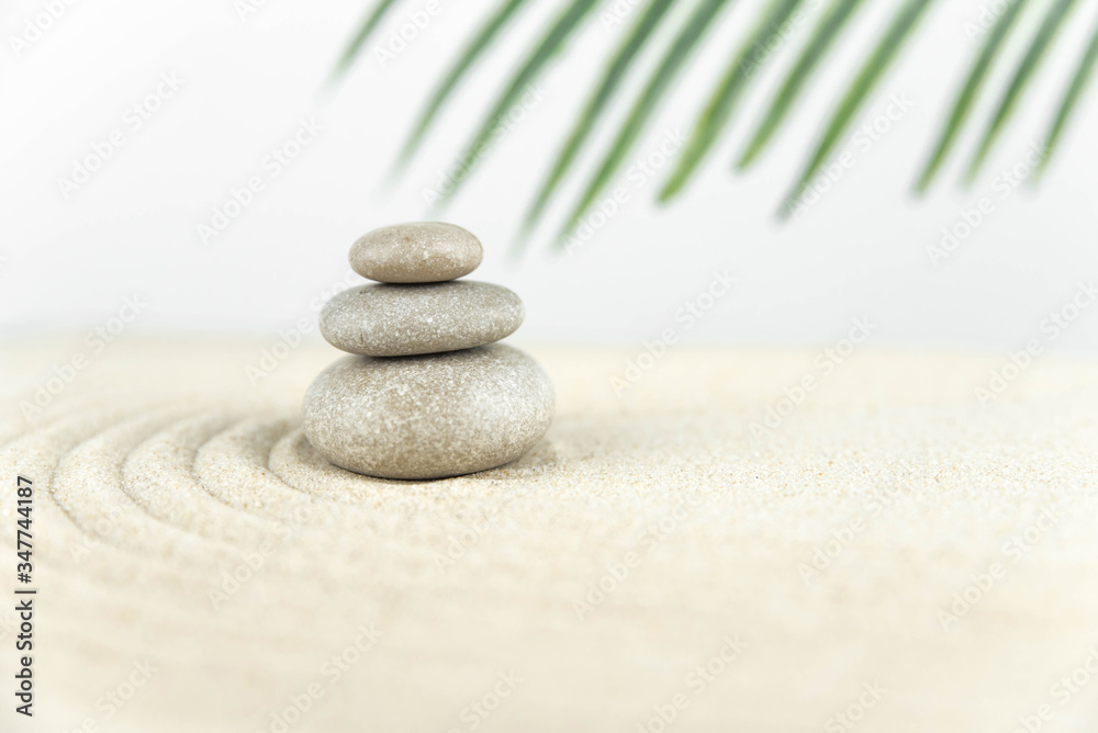 Zen garden. Pyramids of white and gray zen stones on the white sand with abstract wave drawings. Concept of harmony, balance and meditation, spa, massage, relax. Zen garden. Pyramids of white and gray zen stones on the white sand with abstract wave drawings. Concept of harmony, balance and meditation, spa, massage, relax.
