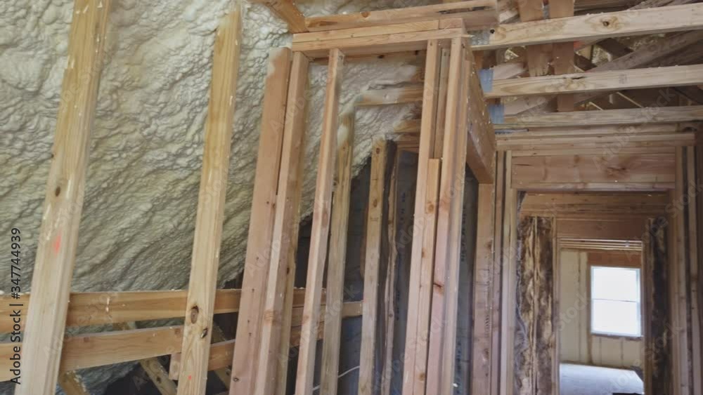 Thermal insulation in process of attic construction frame house a newly constructed home Thermal insulation in process of attic construction frame house a newly constructed home