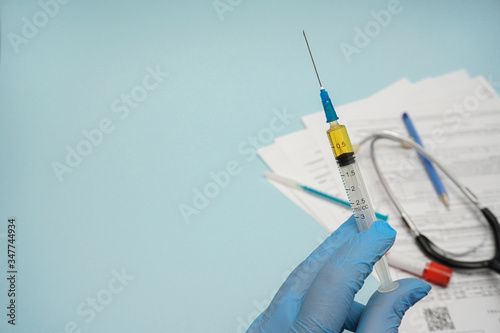 Doctor, nurse, scientist hand in blue gloves holding covid-19 vaccine disease preparing for child, baby, adult, man and woman vaccination shot, medicine and drug concept.