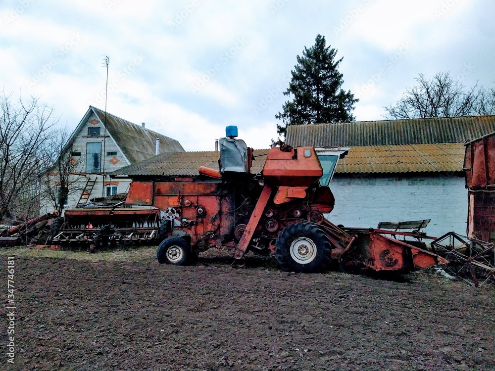 Fototapeta premium Harvester on farm in rural countryside