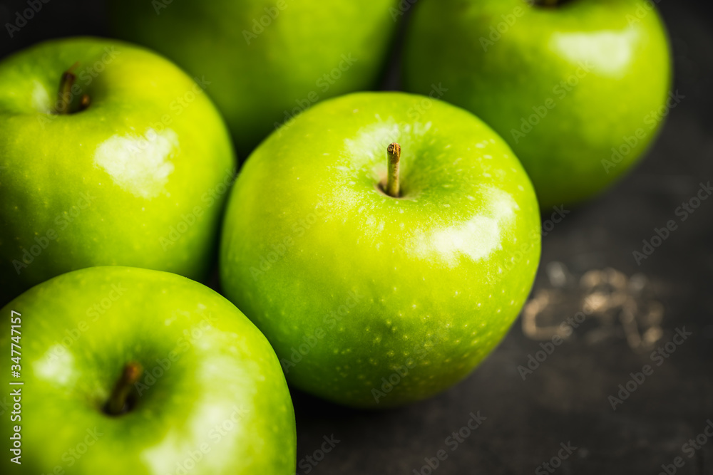 Close-up green apples on the rustic wooden background Close-up green apples on the rustic wooden background