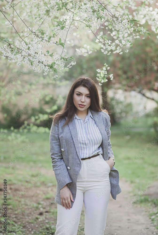 woman in spring casual outfit walking in park woman in spring casual outfit walking in park