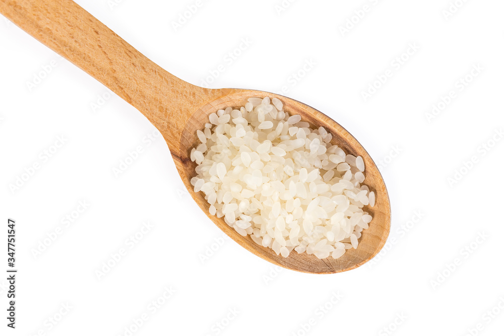Uncooked camolino rice in wooden spoon on a white background Uncooked camolino rice in wooden spoon on a white background